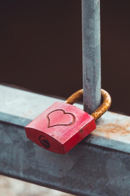 Free Photo closeup shot of a metal padlock with a heart hanging on a fence