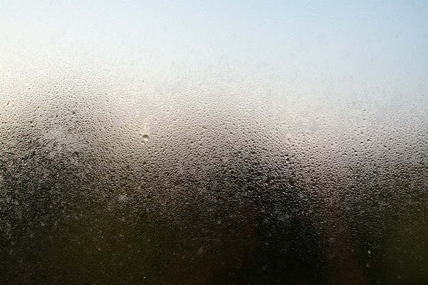 A closeup shot of a misty window with water droplets