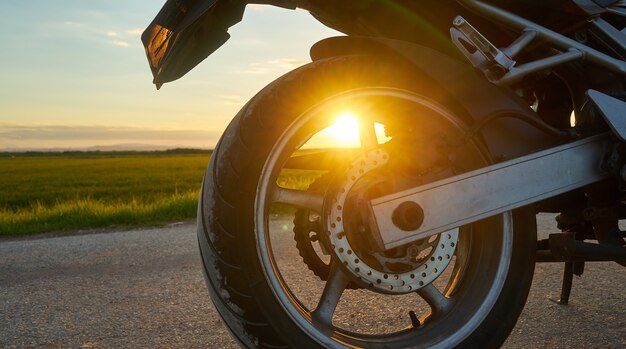 Closeup shot of a motorcycle on a sunset background