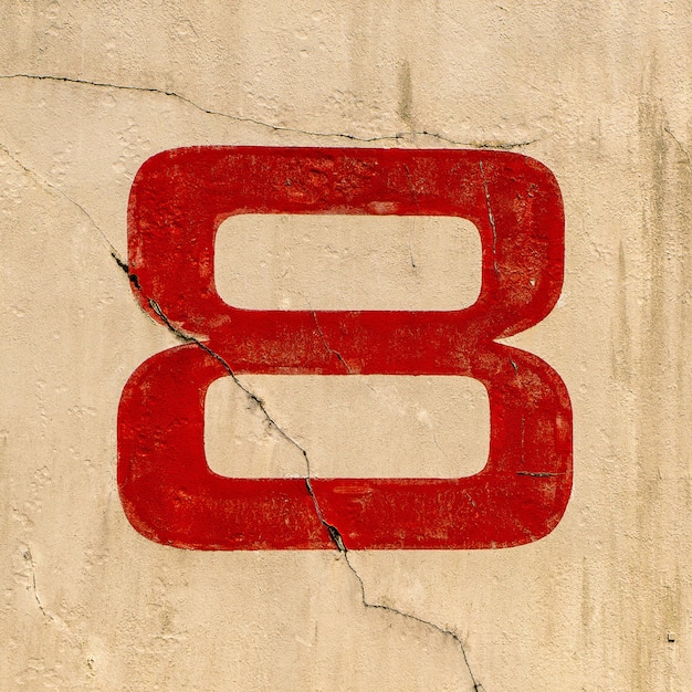 Free Photo closeup shot of the number 8 painted on a wall in red