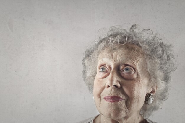 Closeup shot of an old lady with blue eyes and gray hair