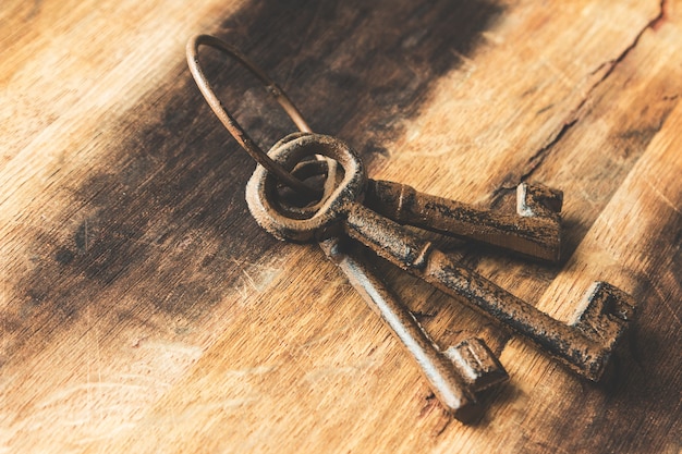 Closeup shot of old rusted keys on a wooden surface