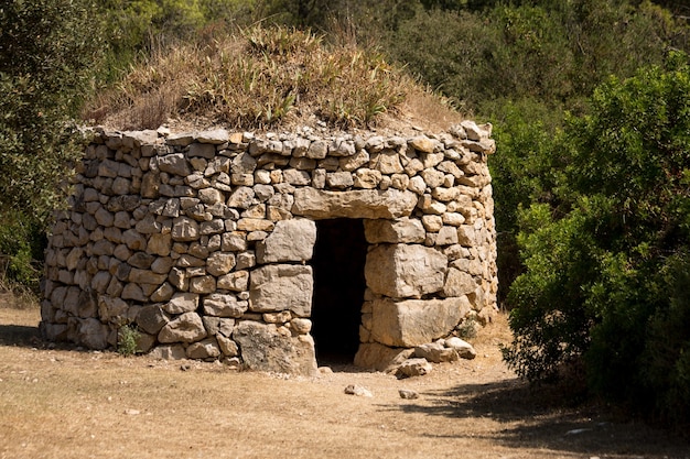 Closeup shot of an old stone shelter in a forest