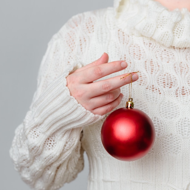 Closeup shot of a person holding a Christmas decoration