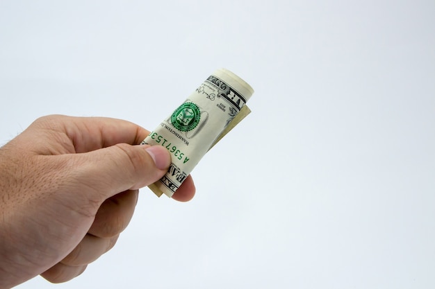 Closeup shot of a person holding a dollar bill over a white background