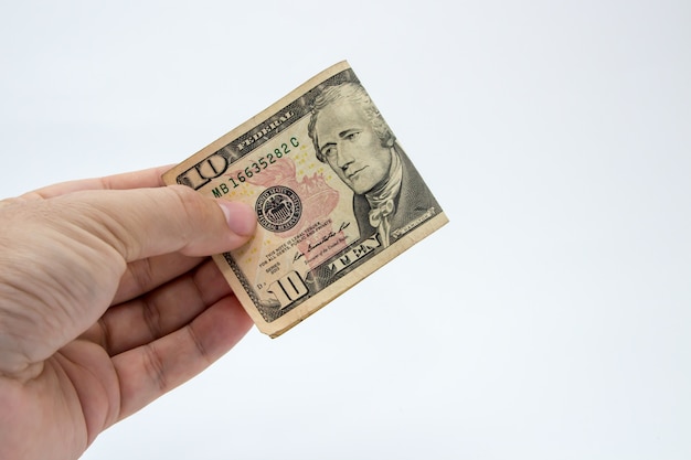 Free photo closeup shot of a person holding a dollar bill over a white background