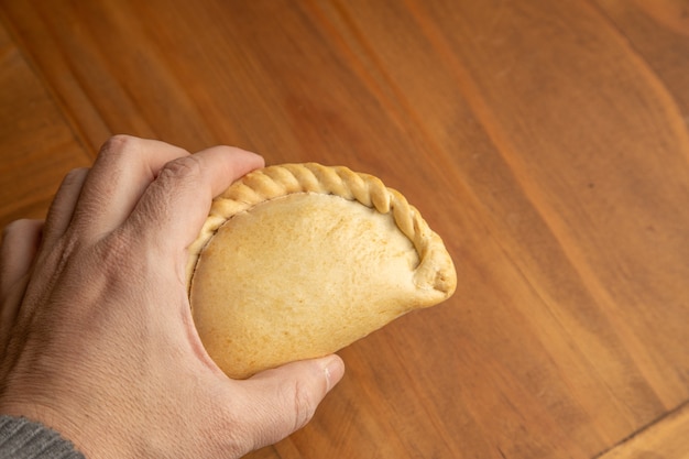 Free photo closeup shot of a person's hand holding a homemade delicious dumpling