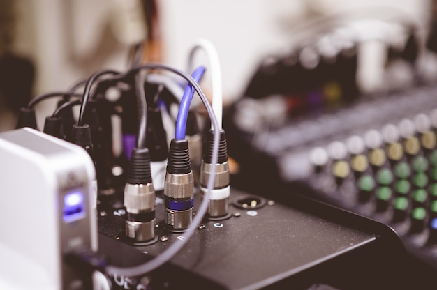 Closeup shot of plugged-in electronic cables on a blurred background