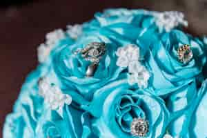 Free photo closeup shot of precious stones on a bouquet with blue roses