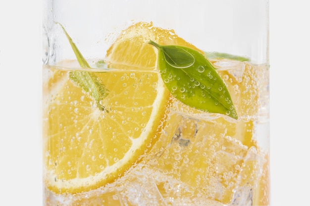 Free photo closeup shot of refreshing drink with orange and green leaf