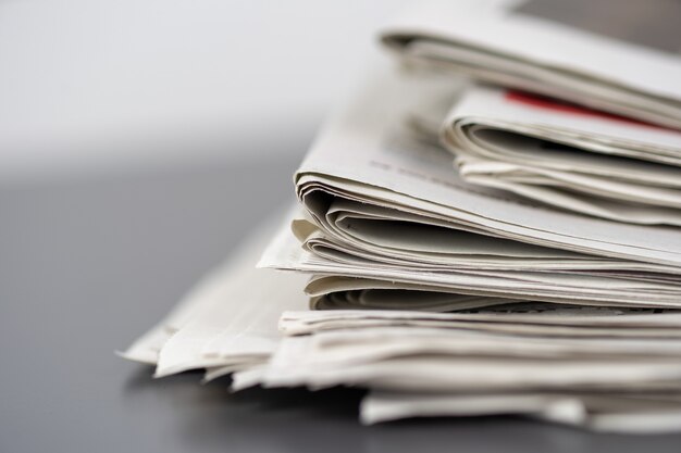 Closeup shot of several newspapers stacked on top of each other