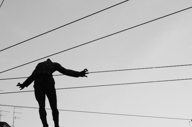 Free photo closeup shot of a silhouette of a person in the air with cables going behind the body