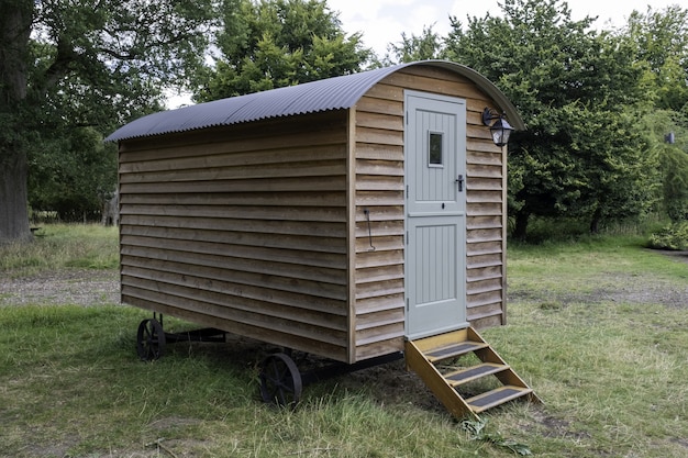 Closeup shot of a small wooden house on wheels