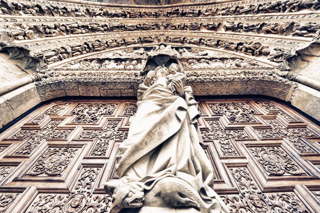 Closeup shot of statues of human figures on an exterior wall of a building