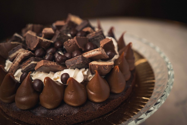 Closeup shot of a tasty chocolate cake on a glass plate on a table