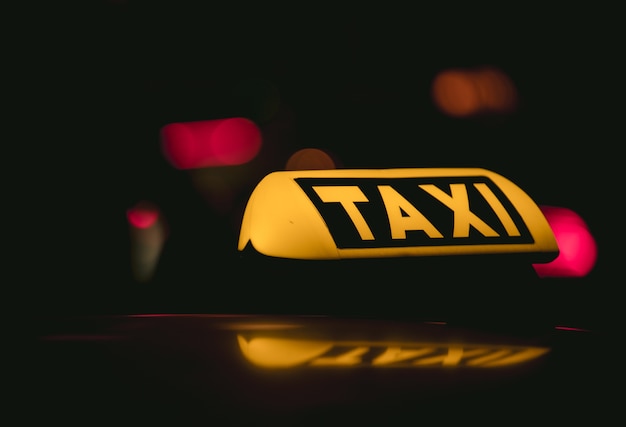 Closeup shot of the Taxi sign placed