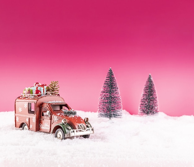 Closeup shot of a toy car for Christmas decoration on snow