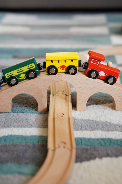 Free photo closeup shot of a toy train on a wooden bridge