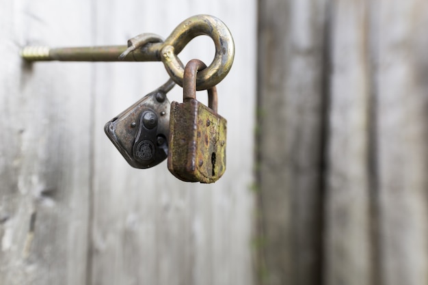 Free photo closeup shot of two rusty locks on a metal handle