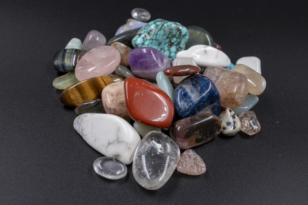 Free photo closeup shot of various polished natural mineral stones against a black background