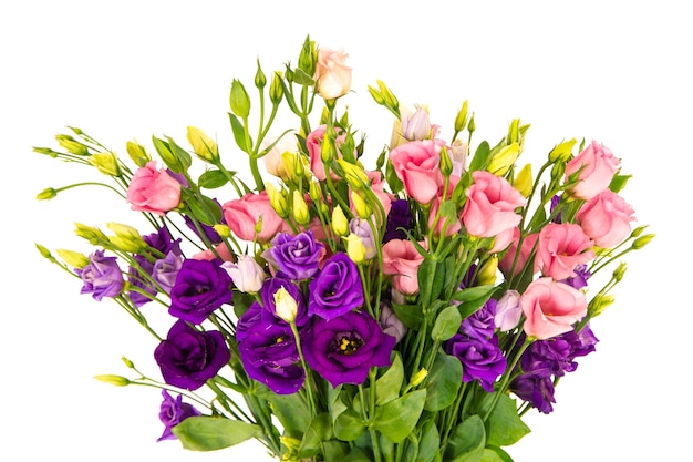 Free photo closeup shot of a vase filled with beautiful pink roses and purple flowers with a white background