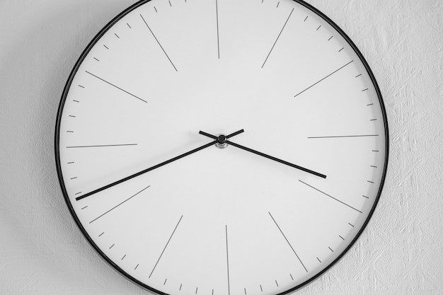 Free Photo closeup shot of a white and black clock on a white wall - the concept of time