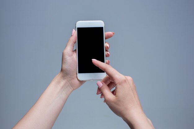 Closeup shot of a woman typing on mobile phone