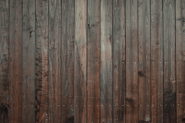 Closeup shot of a wooden floor with dark brown vertical tiles