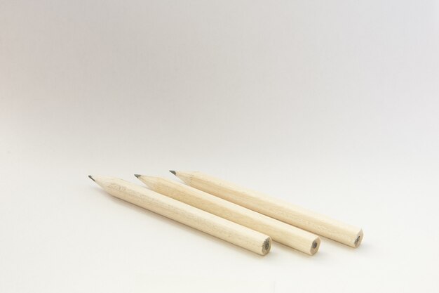 Closeup shot of wooden pencils on an isolated white wall