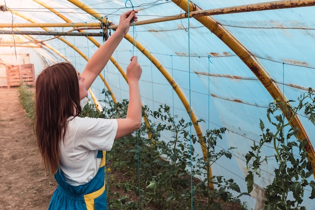 Free photo closeup shot of a young female in a greenhouse