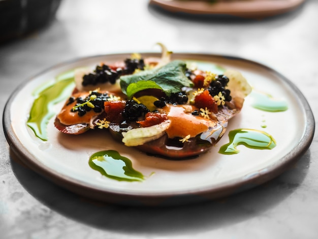 Free photo closeup of a side dish with vegetables and caviar on top with blurred background