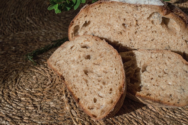 Free Photo closeup on slices of artisan bread lined with straw pieces of fresh homemade sourdough bread wholesome healthy organic food