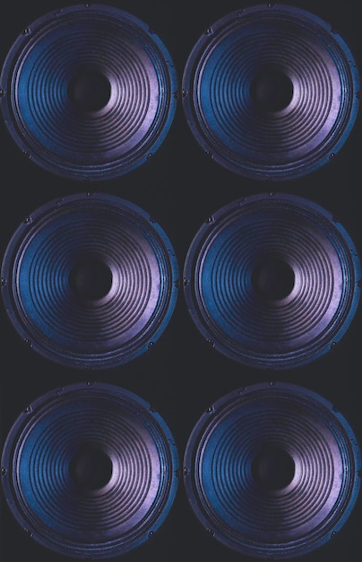 Closeup of speakers membrane on black background with colored lighting