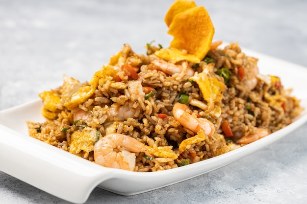 Closeup of spicy cooked rice with meat, shrimp and vegetables in a plate