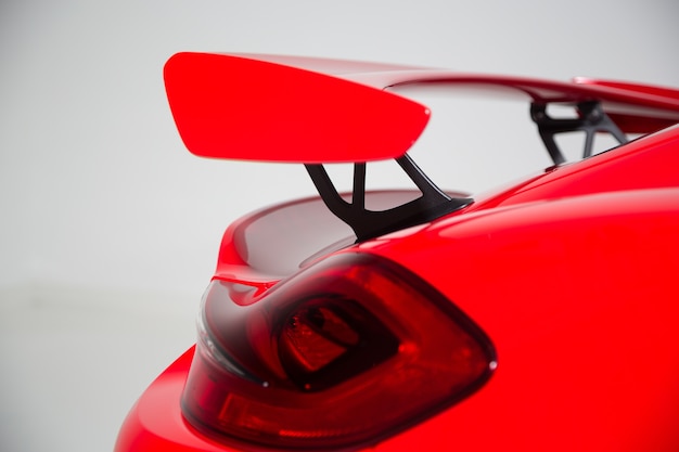 Free photo closeup of a spoiler on a red modern sports car under the lights isolated