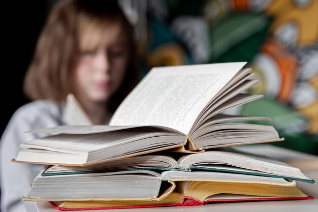 Closeup of a stack of open books on a blurred background