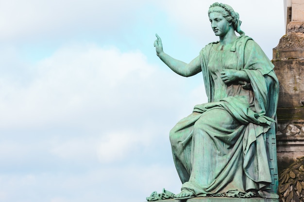 Closeup of the statue of the Congress Column under the sunlight and a cloudy sky in Brussels