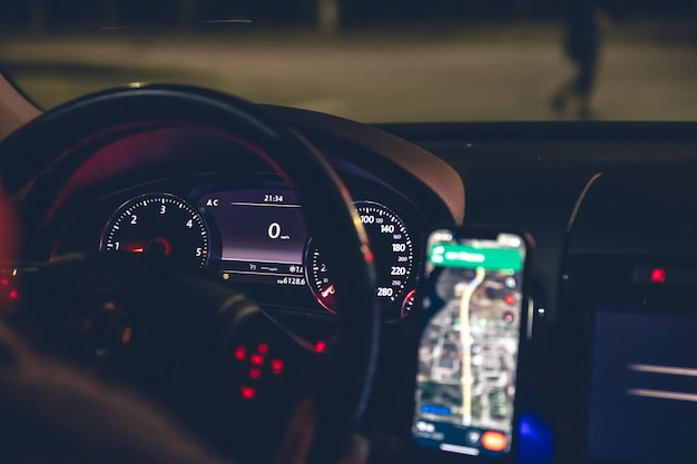 Closeup steering wheel and navigator in a car at night