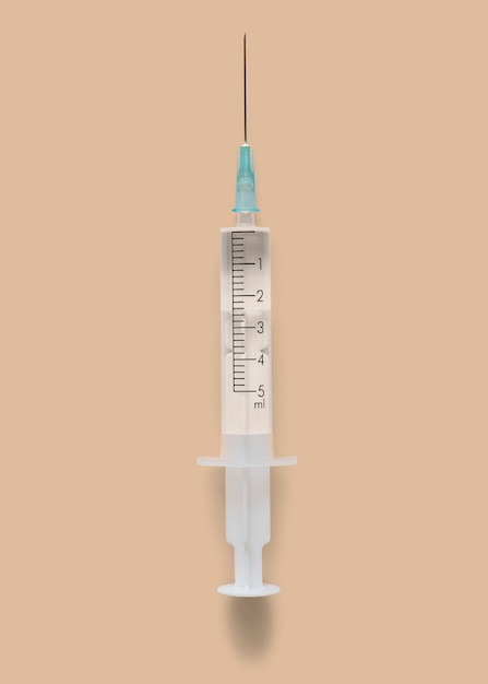 Free photo closeup of a syringe on a brown background