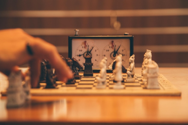 Closeup of a table with people playing chess on a tournament