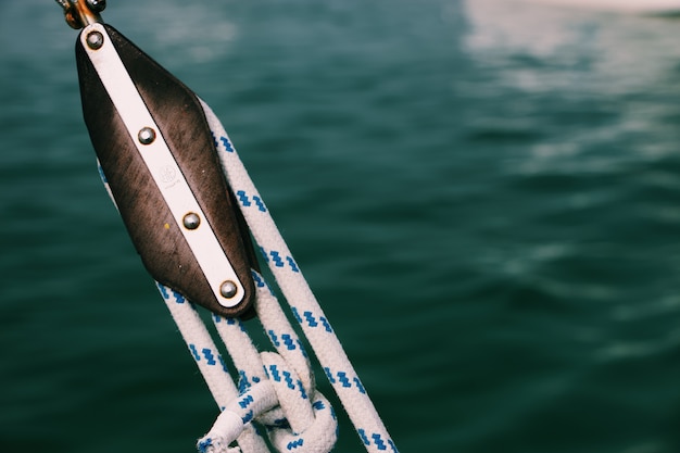 Free Photo closeup of tight ropes on a fishing boat with a blurred sea