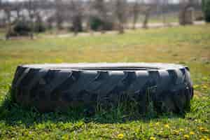 Free photo closeup of a tire on a field with yellow flowers