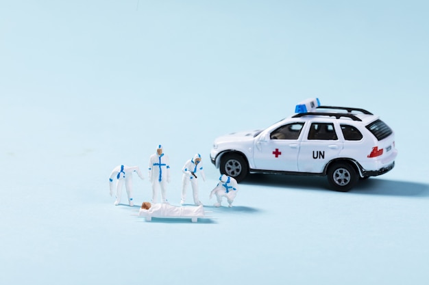 Free Photo closeup of toy ambulance and paramedics helping a patient