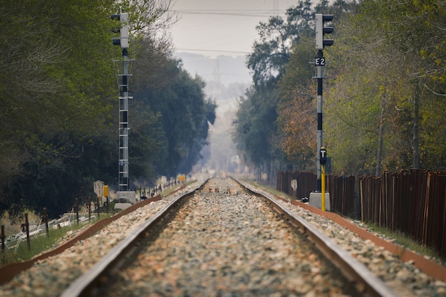 Free photo closeup of train rails and a wooden fence on the right