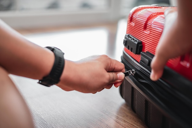 Free photo closeup of traveler man have finished packing and is locking them man is preparing clothes in suitcases travel holiday and vacation concept