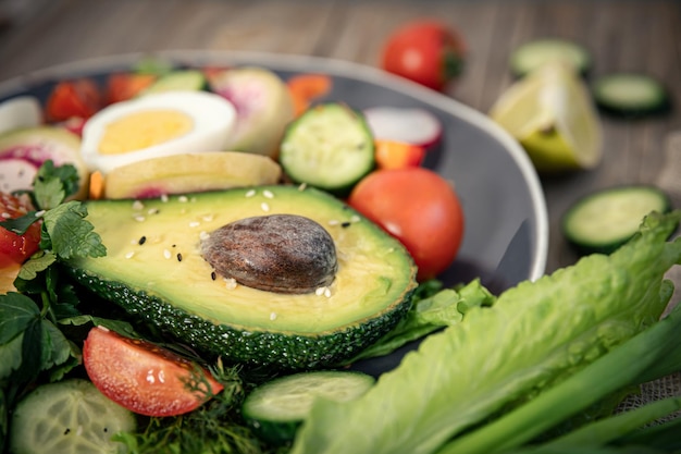 Closeup vegetable salad with avocado and eggs