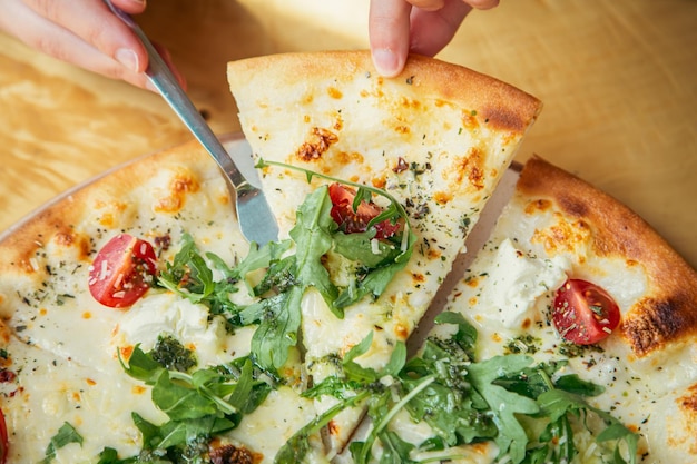 Closeup vegetable vegetarian pizza on a wooden table top view