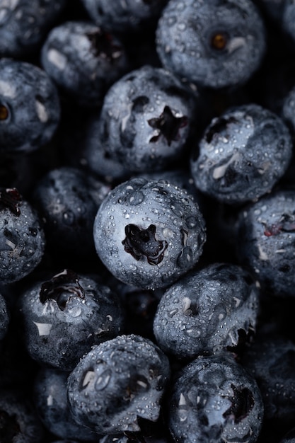 Closeup vertical shot of blueberries with water droplets