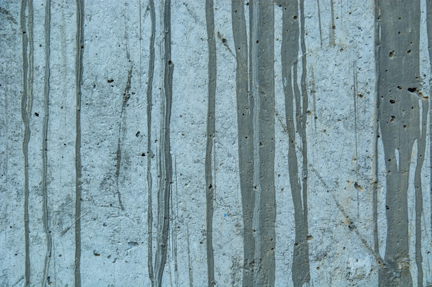 Free photo closeup of a weathered grungy rustic wall with paint spots and old cement - perfect grunge wallpaper