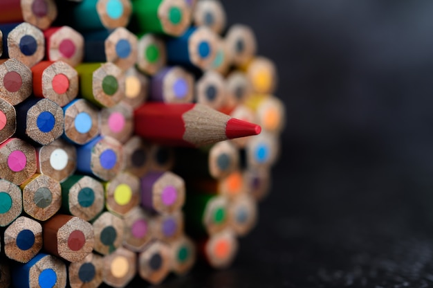 Closeup with a group of colored pencils, selected focus, red